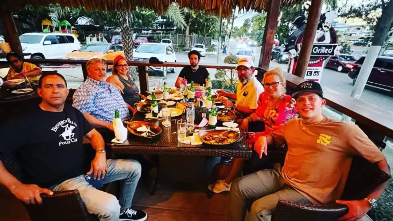A group of customers sharing a meal at a restaurant during a tour